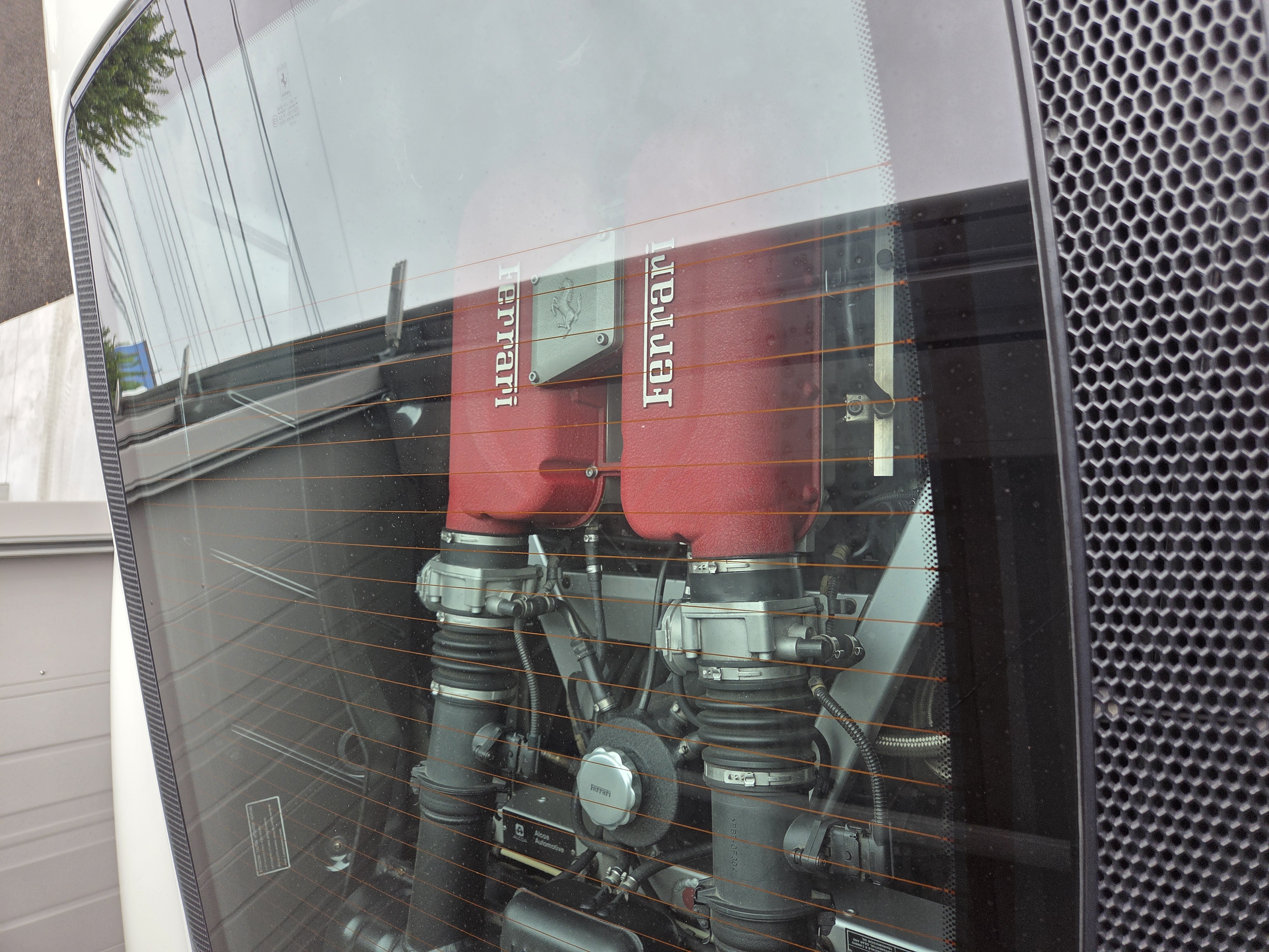 フェラーリ360モデナのリアガラス越しに見える3.6L V8エンジン